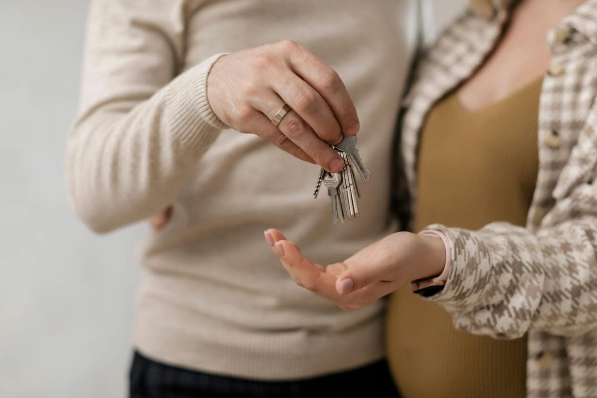 Couple receiving keys to their new home — the owner-occupier path through new-construction pre-sale incentives.